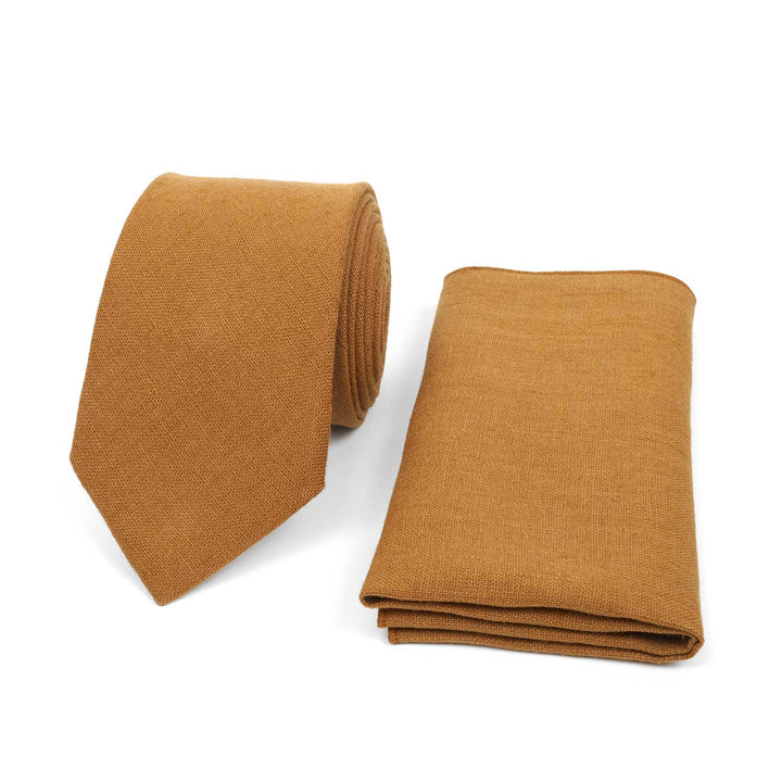 Cinnamon brown linen necktie and matching pocket square set, earthy rust-toned wedding accessories on a white background.