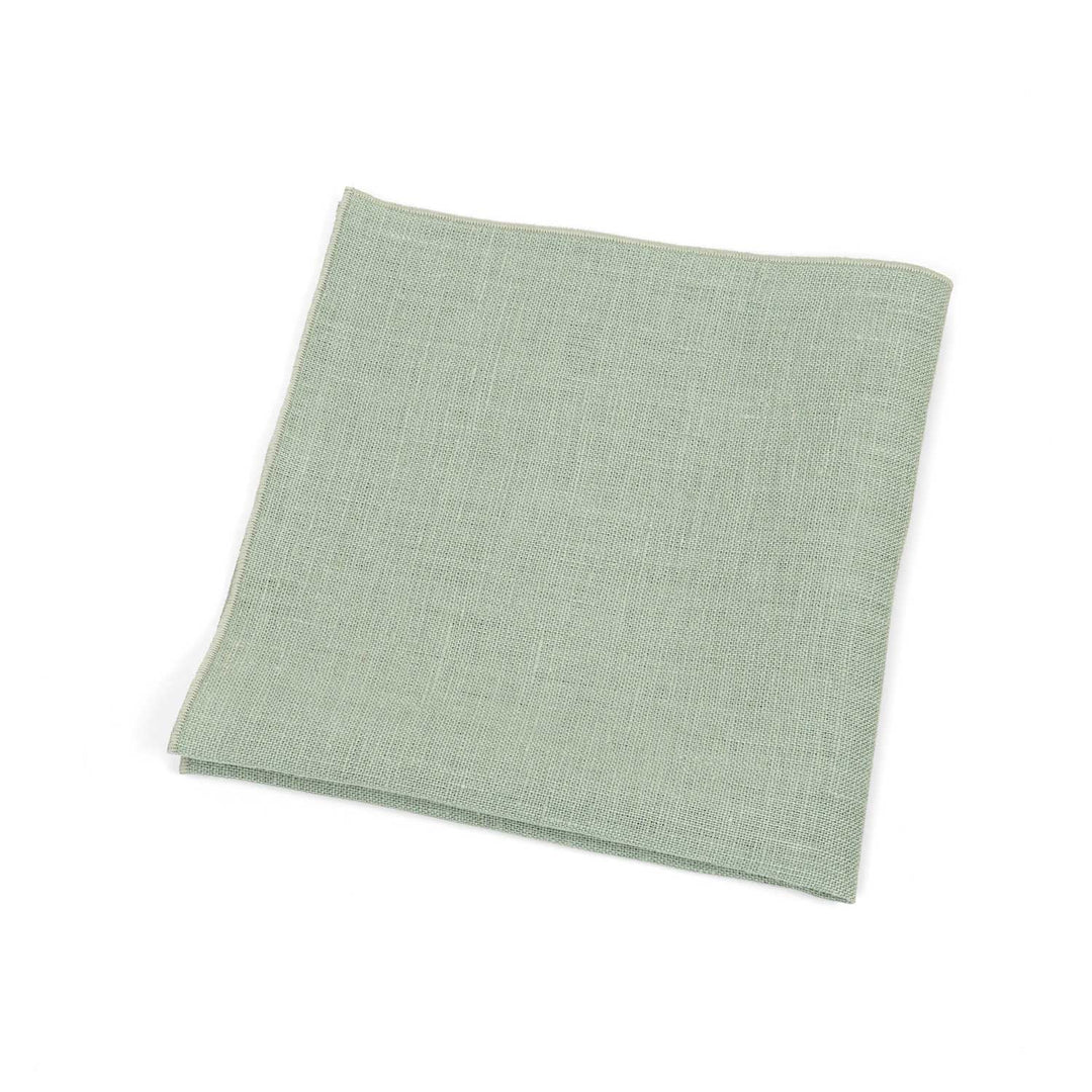 Folded linen light sage green linen pocket square for men, isolated on a white background.