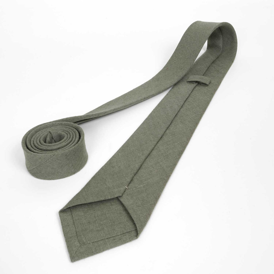 Back view of a regular green necktie on a white background, showcasing the keeper loop, stitching, and fabric construction.