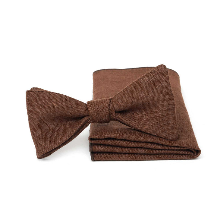 Rustic brown linen pre-tied bow tie and matching pocket square set by Hemmitie on a white background.