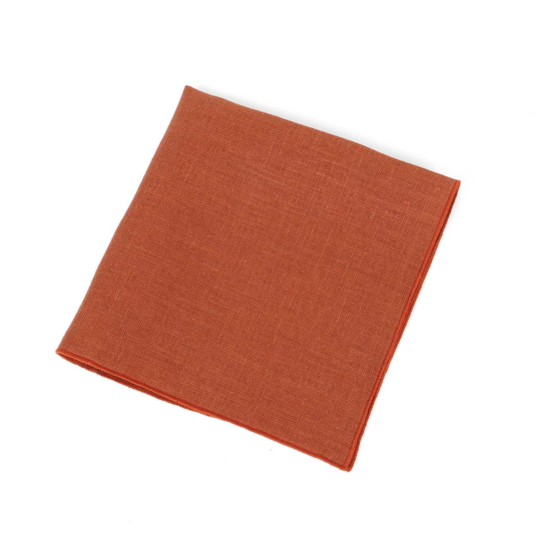 Terracotta linen pocket square by Hemmitie, showing the natural texture of the fabric.