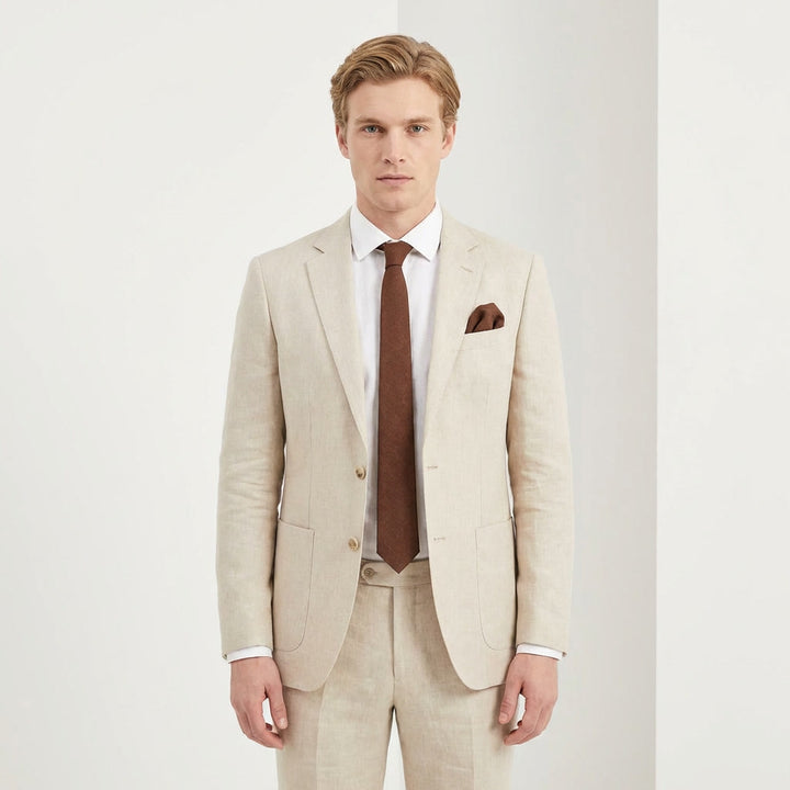 A man wearing a modern brown linen necktie and a white dress shirt, paired with a beige suit for a rustic wedding look.