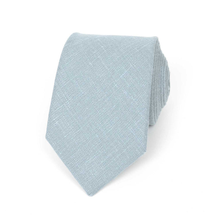 A pale blue linen necktie with a visible textured weave, laid flat against a clean white background.