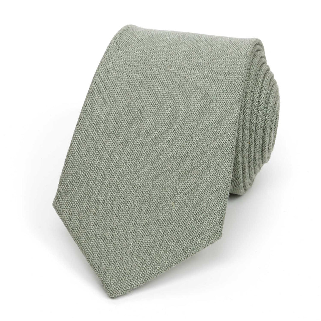 Modern sage green necktie made of textured linen fabric, isolated on a white background.