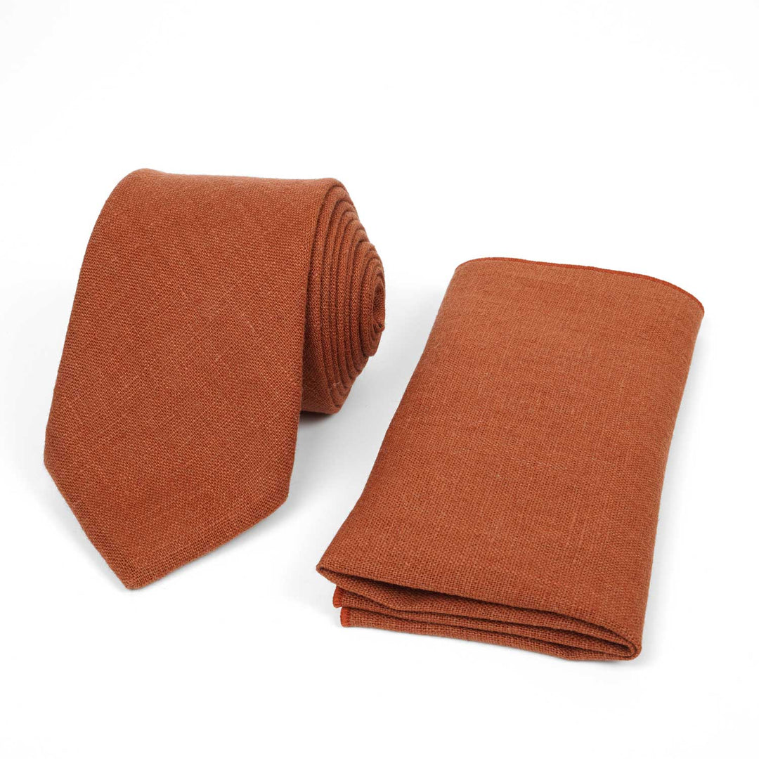 Summer terracotta linen necktie and matching pocket square set, rust-colored wedding accessories on a white background.